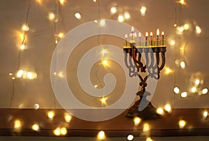 Low key image of jewish holiday Hanukkah background with menorah & x28;traditional candelabra& x29; and burning candles