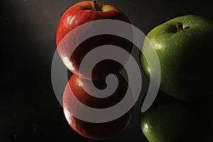 Low key lighting two reflected apples with applying rule of thirds photo