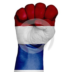 Low key picture of a fist painted in colors of netherlands flag