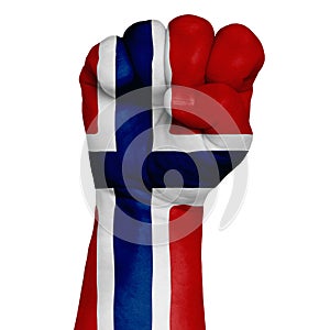 Low key picture of a fist painted in colors of norway flag