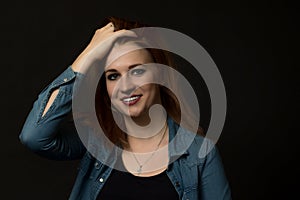 Low key portrait of laughing young woman