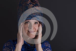 low key portrait of mature Ukrainian woman in in blue oriental clothes