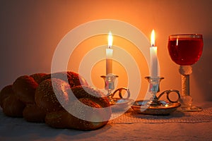 Low key shabbat image. challah bread, shabbat wine and candelas
