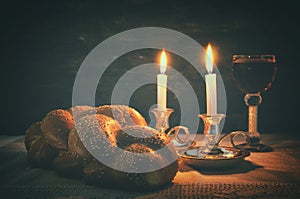 Low key shabbat image. challah bread, shabbat wine and candles