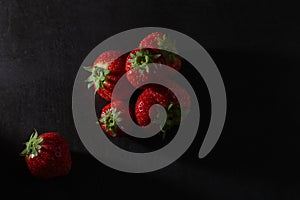 Low key strawberries on a dark background
