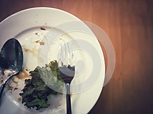 Low key vintage style of left over food on wood table with copy space