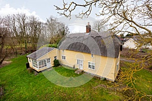 Low level aerial 17th century thatched cottage
