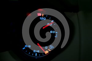 Low level fuel warning light in car dashboard.