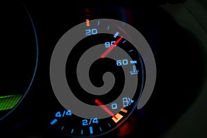 Low level fuel warning light in car dashboard.