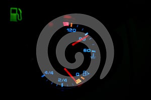Low level fuel warning light in car dashboard.