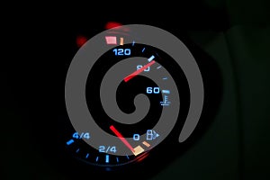 Low level fuel warning light in car dashboard.
