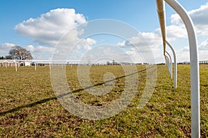 Low level view along an empty horse racing course on a bright and sunny day