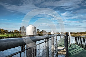 Low level view of metal railings and a jetty slipway.