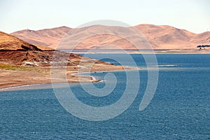 Low levels of water in the St Luis Reservoir, CA. photo