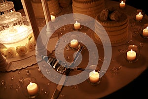 Low light photo of wedding cake with candles