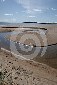 Low Newton, UK - 13 July, 2023: Views of Dunstanburgh castle and the Northumbria coast, Low Newton by the Sea