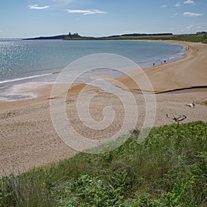 Low Newton, UK - 13 July, 2023: Views of Dunstanburgh castle and the Northumbria coast, Low Newton by the Sea