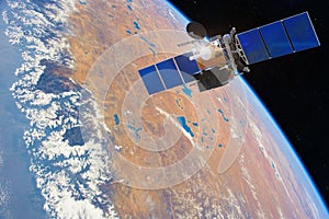 Low-orbit communication satellite in space above the Earth. Elements of this image furnished by NASA photo