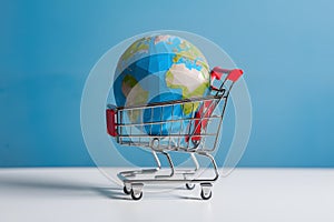 Low poly global depicted on white background within shopping cart