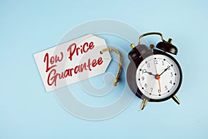 Low Price text on price tag with alarm clock on blue background