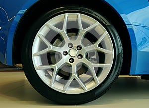 Low profile tire on multi-spoke sports vehicle rim front view