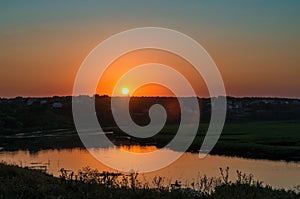 Low red sunset over river