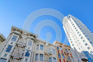 Low-rise apartment buildings beside the high-rise building in a low angle view at San Francisco, CA
