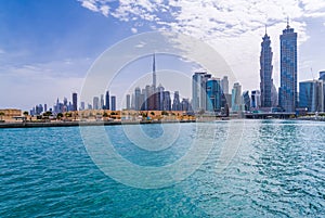 Low rise homes in front of modern apartments of Dubai Downtown district