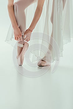 low section of ballerina wearing ballet shoes,