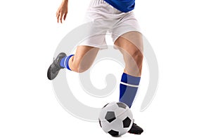 Low section of biracial young female soccer player kicking soccer ball against white background