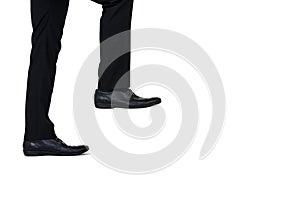 Low section of businessman climbing steps