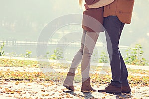 Low section of couple standing in park during autumn