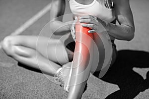 Low section of female athlete suffering from joint pain