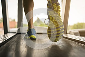 Low section of man exercising on treadmill.