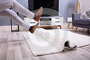 Man Legs Stumbling With A Carpet photo