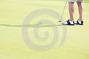 Low section of middle-aged man playing golf