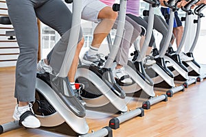 Low section of people working out at spinning class