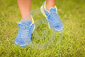 Low section of person walking on grass