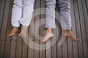 Low section of senior couple lying at porch