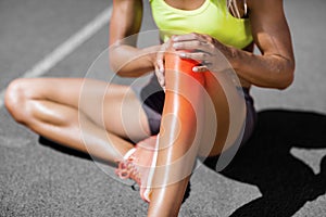 Low section of sportswoman suffering from joint pain photo