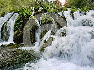 Low shutter speed of beautiful waterfalls, Plitvice lakes national park UNESCO, dramatic unusual scenic, green foliage alpine