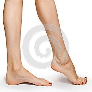 Low side view of woman foot on white background, close-up