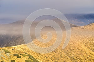 Low Tatras mountain ridge under mist during autumn, view from Skalka mountain