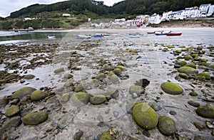 Low tide, beach and boats.