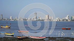 Low-tide, boats tied to the shore close to fishermenâ€™sâ€™ village known as Worli Koliwada