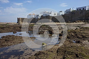 Low tide in front of the historical rampart to protect Assilah photo