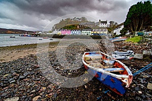 Low tide at the harbour in Portree, Scotland with colorful buildings in the background