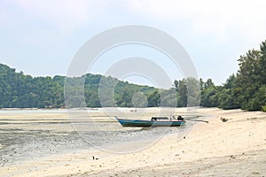 Low tide in a shallow bay, the boat is aground