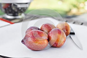 Low View of Amigo Pluot Fruits with a Knife