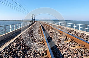 Low view of the curved concrete bridge of the railway line along the reservoir